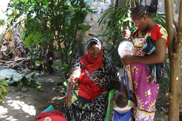 Gladicy Kadzo, together with her son, is one of the beneficiaries of Mwanamkasi's community awareness initiative. [Marion Kithi]