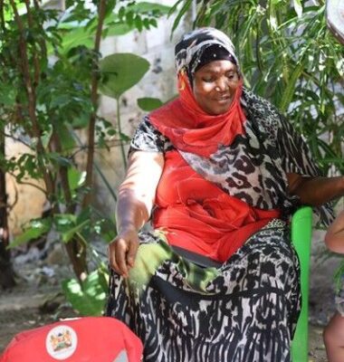 Mwanamkasi Hassan, a community health Promoter [CHP] in Kasarani village in Kilifi county, displaying a MUAC bracelet which helps mothers recognise signs of malnutrition in their children [Marion Kithi]